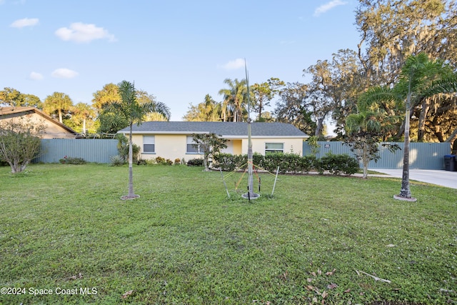 ranch-style home featuring a front yard