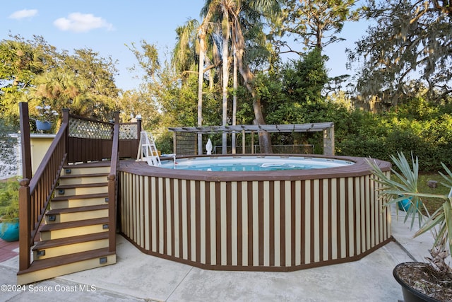 view of swimming pool with a pergola