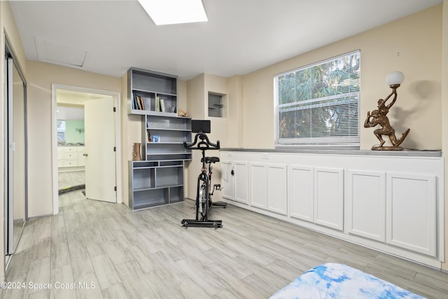 workout room with light hardwood / wood-style flooring