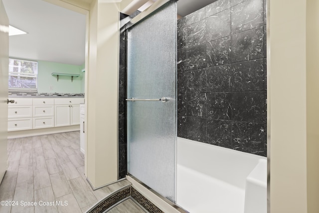 bathroom with vanity, hardwood / wood-style flooring, and an enclosed shower