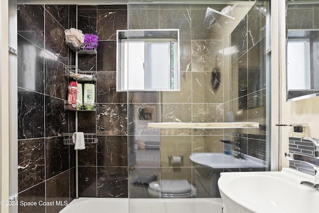 bathroom featuring sink, tile walls, and toilet