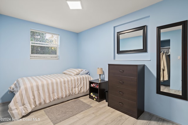 bedroom with a closet and light hardwood / wood-style flooring