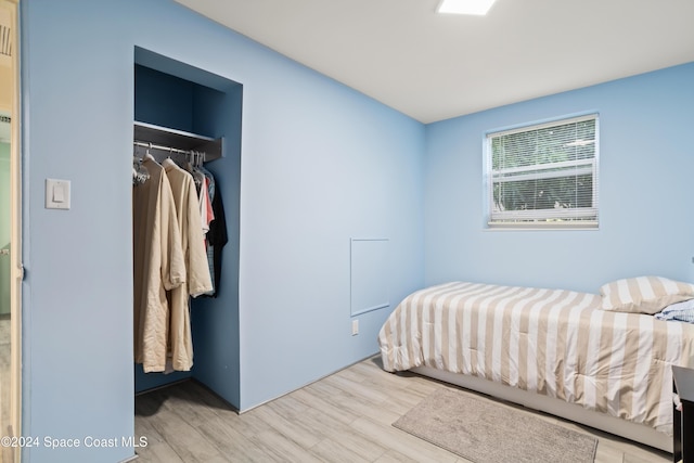 bedroom featuring light hardwood / wood-style floors and a closet