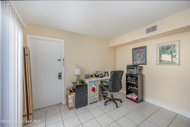 office with light tile patterned floors and a textured ceiling