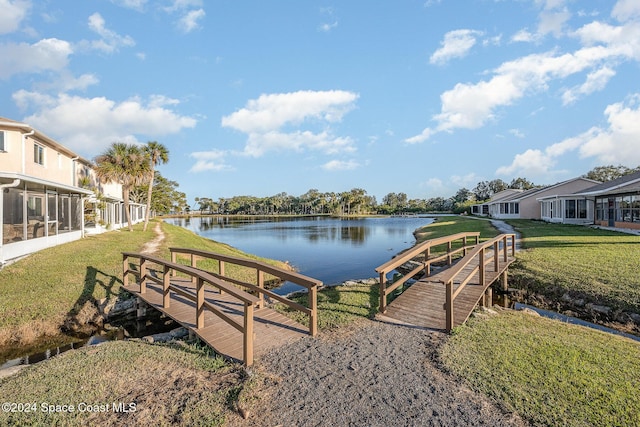 exterior space with a water view and a yard