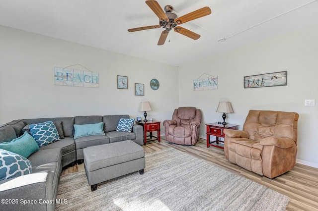 living room with ceiling fan and hardwood / wood-style floors