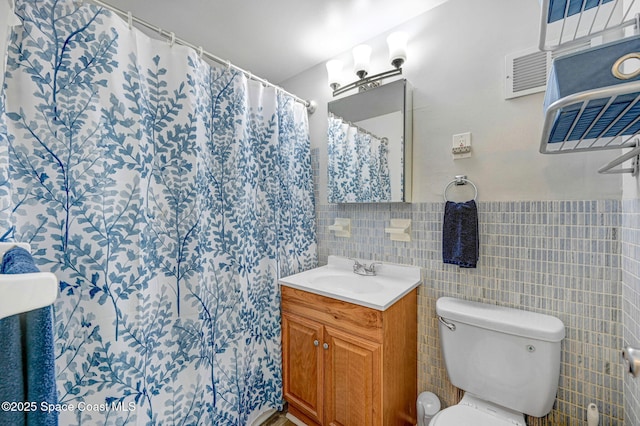 bathroom featuring a shower with curtain, vanity, tile walls, and toilet