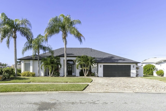 ranch-style home with a front yard and a garage