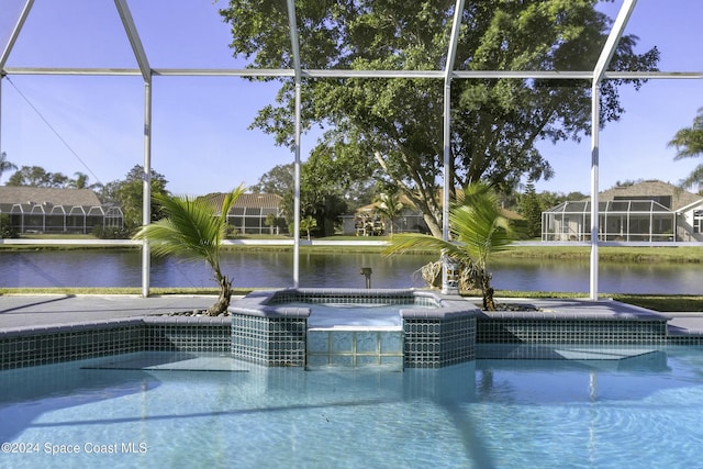 view of swimming pool featuring glass enclosure, an in ground hot tub, and a water view