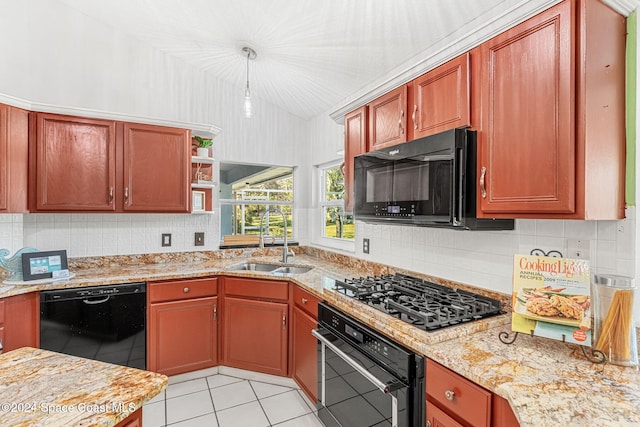 kitchen with black appliances, light stone counters, light tile patterned floors, and sink