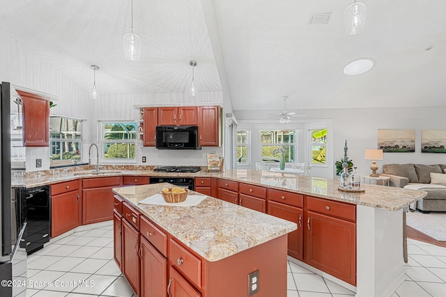 kitchen featuring sink, pendant lighting, a center island, and black appliances