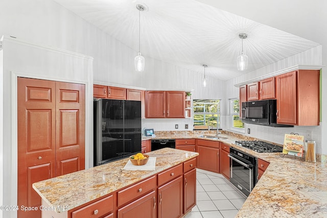 kitchen featuring pendant lighting, sink, light stone counters, and black appliances