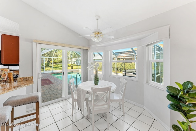 sunroom / solarium featuring plenty of natural light, ceiling fan, and vaulted ceiling