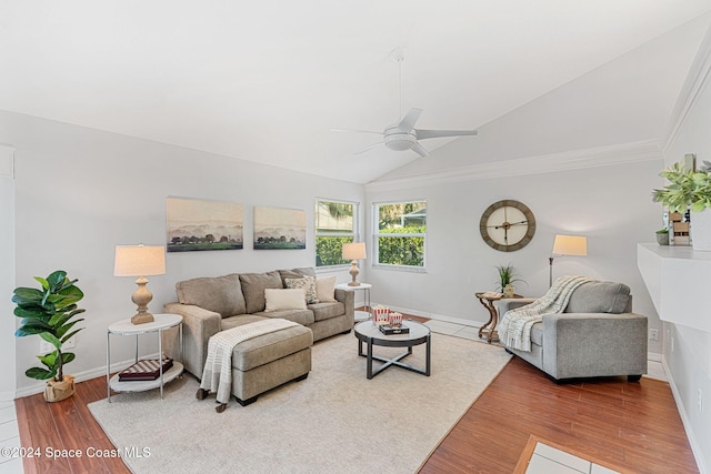 living room with wood-type flooring, vaulted ceiling, ceiling fan, and ornamental molding