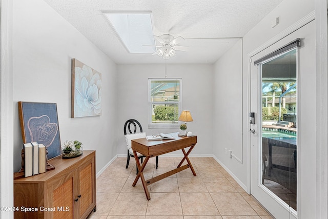 office space with ceiling fan, a healthy amount of sunlight, and light tile patterned flooring