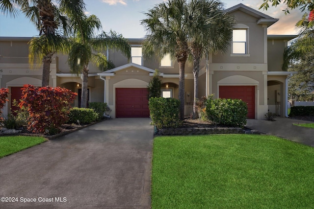 view of front of house with a yard and a garage