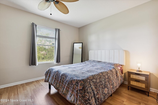 bedroom with hardwood / wood-style floors and ceiling fan