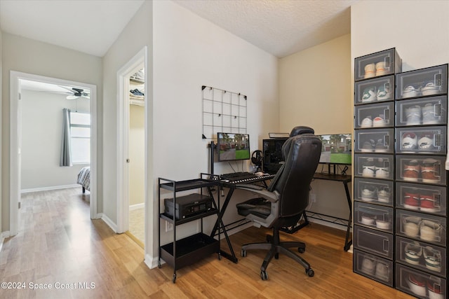 office space featuring a textured ceiling, hardwood / wood-style flooring, and ceiling fan