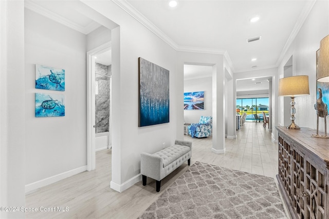 corridor featuring visible vents, wood finished floors, and crown molding