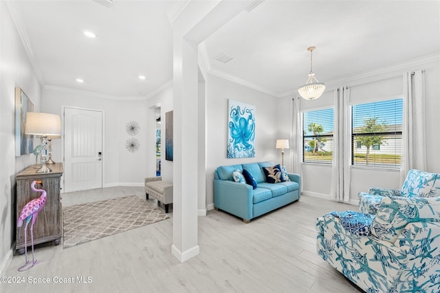 sitting room with recessed lighting, wood finished floors, baseboards, and ornamental molding