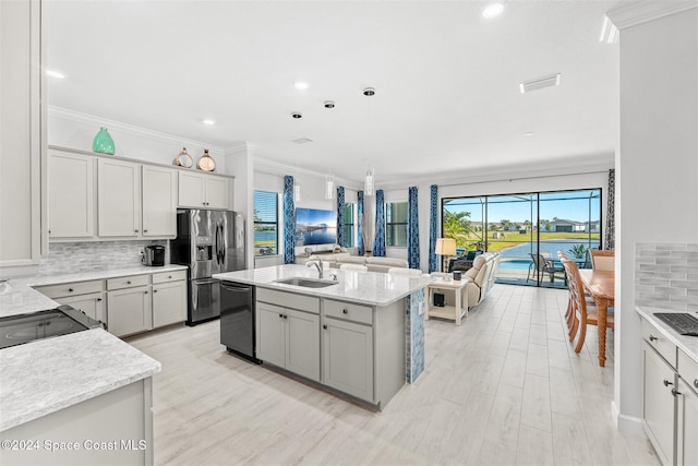 kitchen featuring stainless steel fridge with ice dispenser, a sink, dishwasher, open floor plan, and backsplash