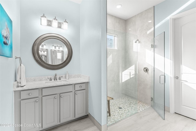 bathroom with vanity and a shower stall