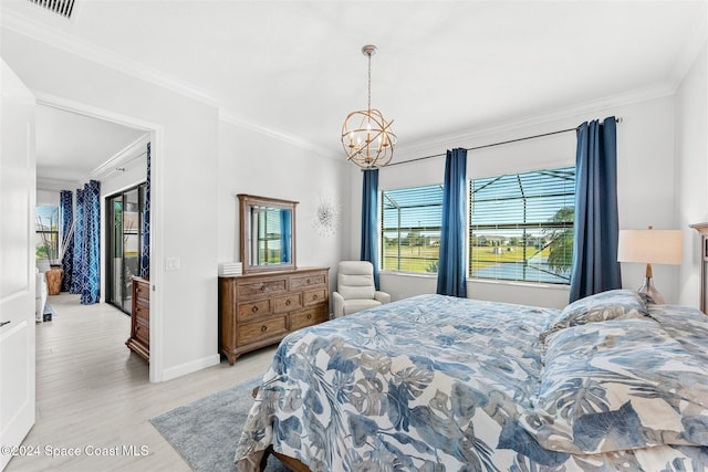 bedroom featuring visible vents, crown molding, an inviting chandelier, and wood finished floors