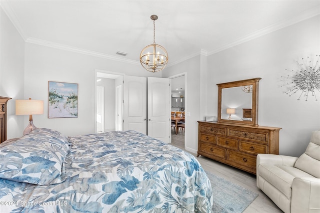 bedroom with visible vents, light wood-style flooring, crown molding, and an inviting chandelier