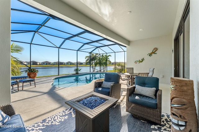 view of patio / terrace with glass enclosure, an outdoor pool, a fire pit, and a water view