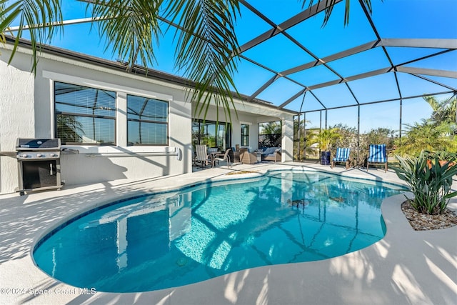 pool with area for grilling, a lanai, and a patio area