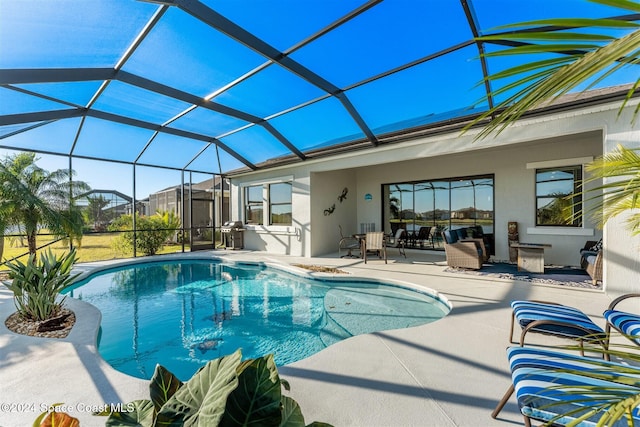 pool featuring glass enclosure and a patio