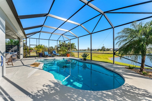 pool featuring glass enclosure, a patio, and a yard