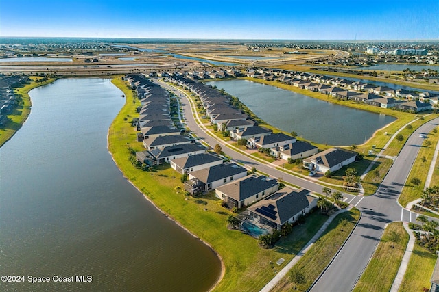 birds eye view of property featuring a residential view and a water view