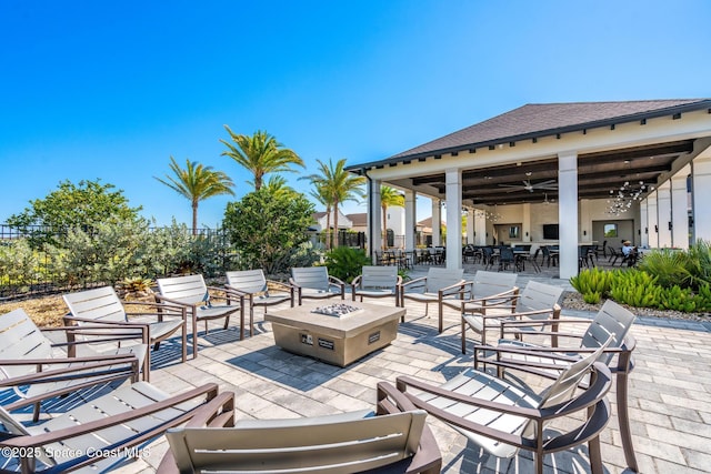 view of patio featuring an outdoor living space with a fire pit and fence