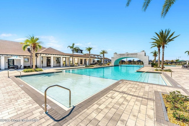 pool featuring a patio area and a water slide