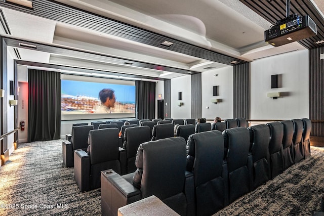 carpeted home theater room featuring a tray ceiling