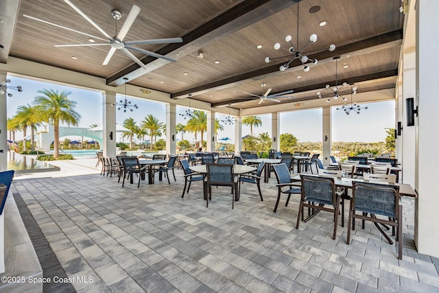 view of patio with outdoor dining area and a ceiling fan