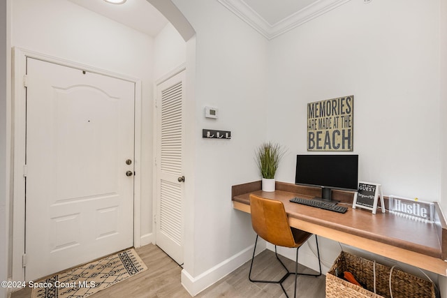 office area featuring light wood-type flooring and ornamental molding