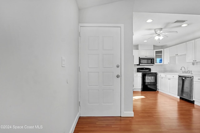 kitchen featuring lofted ceiling, light hardwood / wood-style flooring, ceiling fan, white cabinetry, and stainless steel appliances