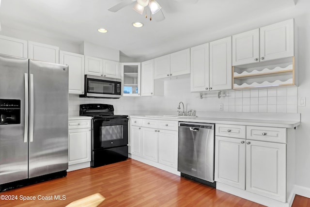 kitchen featuring white cabinets, appliances with stainless steel finishes, and light hardwood / wood-style floors