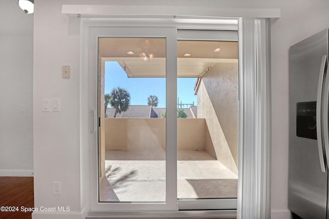 doorway to outside featuring plenty of natural light and wood-type flooring