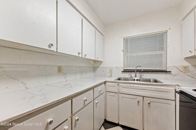 kitchen featuring decorative backsplash, sink, white cabinets, and white electric stove