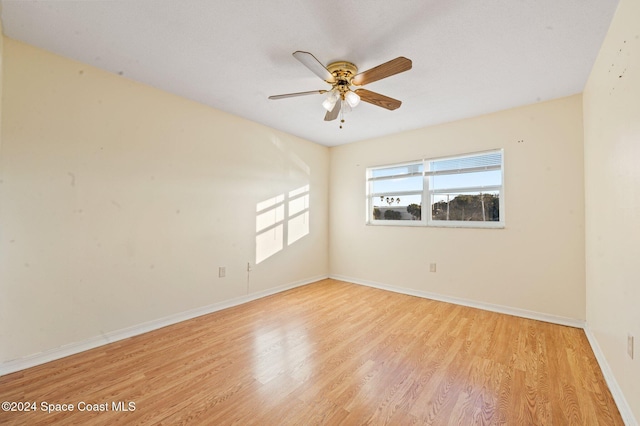 spare room featuring ceiling fan and light hardwood / wood-style flooring