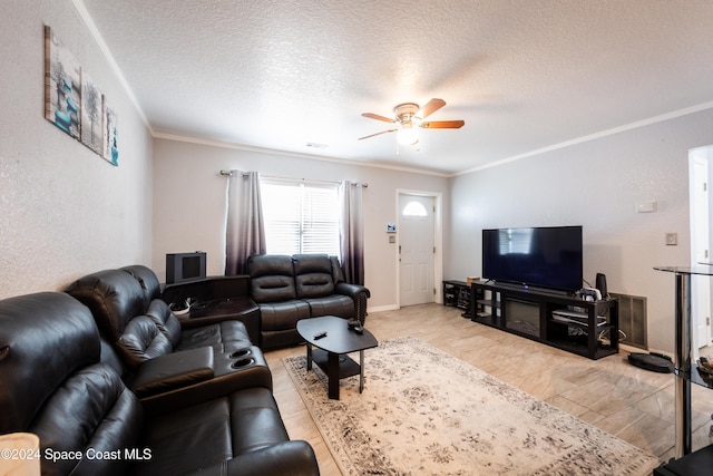 living room featuring crown molding, ceiling fan, and a textured ceiling