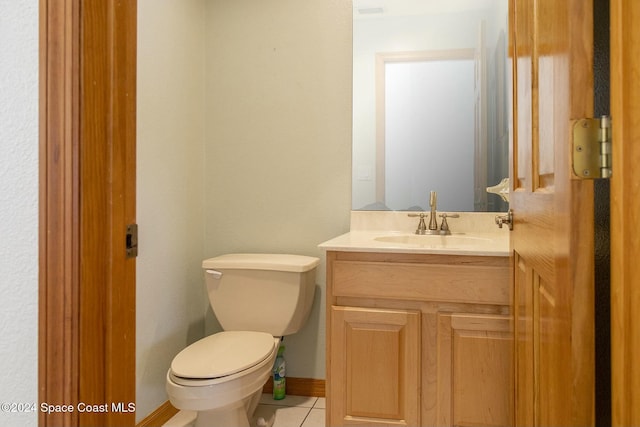 bathroom with tile patterned flooring, vanity, and toilet