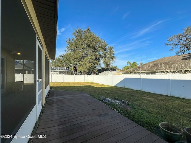 wooden deck featuring a yard