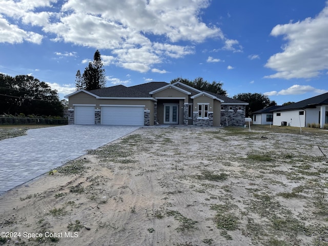 view of front of property with a garage and french doors