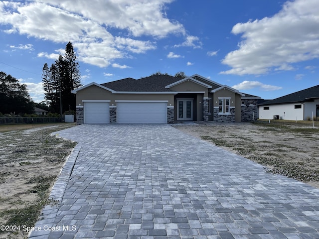 view of front of property with french doors and a garage