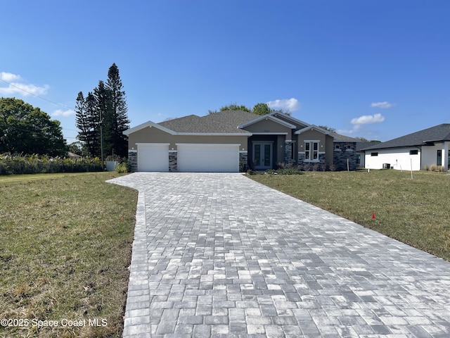 view of front of house with a garage and a front yard