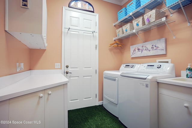 clothes washing area with cabinets and independent washer and dryer